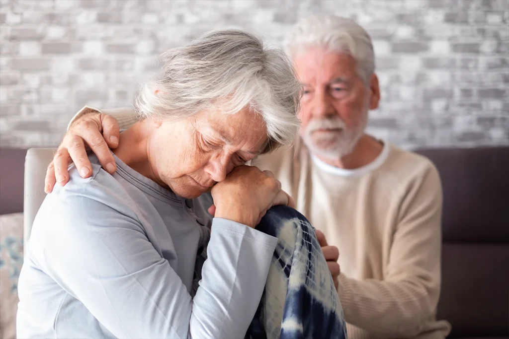 A husband comforting his wife after suffering from grief and loss