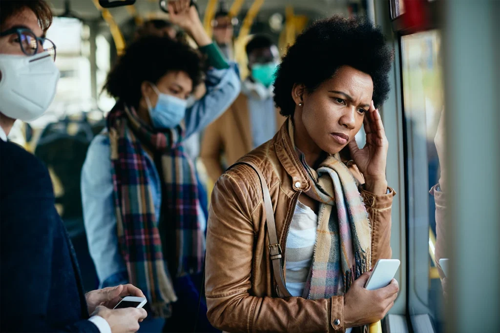 A woman in public working to manage stress and find calm